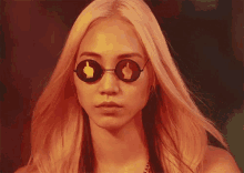 a woman wearing sunglasses with a middle finger on the lens