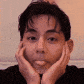 a young man is sticking his tongue out while making a funny face
