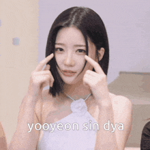 a woman in a white dress with the words yooyeon sin dya written on the bottom