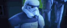 a storm trooper is sitting in front of a computer monitor