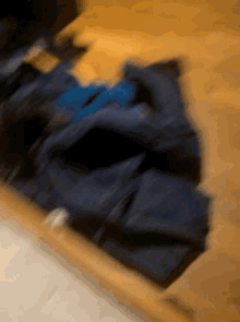 a blurred image of a person laying on a wooden floor
