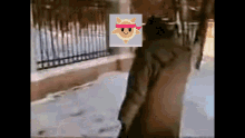 a person walking down a sidewalk with a picture of a sun on their head