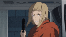 a woman in a red hoodie is holding a black object
