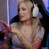 a woman wearing headphones and a necklace with a pendant that says ' i love you ' on it