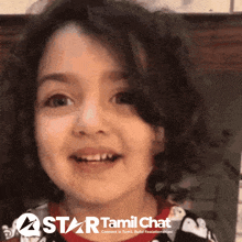 a little girl is smiling in front of a star tamil chat banner