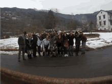 a group of people are posing for a picture in front of snowy mountains