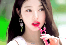 a close up of a woman 's face with a pink straw in her mouth and the word live on the bottom right corner
