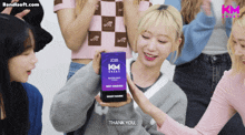 a girl is holding a box with km on it