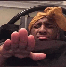 a man with a turban on his head is laying in bed .