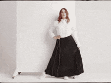a woman with red hair and a silver bracelet on her wrist