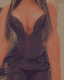 a woman wearing sunglasses and a black top with a plunging neckline