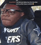a man wearing glasses and a very ers sweatshirt