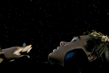a person laying down with their eyes closed and smoke coming out of their mouth