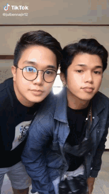 two young men are posing for a picture with a tik tok watermark