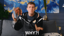 a man sitting on a couch with the word why written on his chest