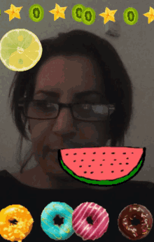 a woman wearing glasses is surrounded by donuts and fruits