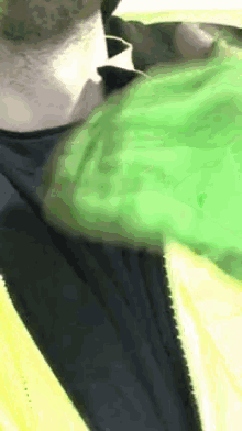 a close up of a man wearing a yellow and black jacket .