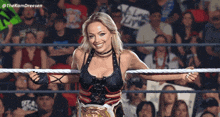 a woman in a wrestling ring with a sign that says " alone live "