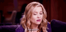 a woman is sitting on a couch with her eyes closed and saying `` epic failure '' .
