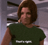 a woman in a green shirt is smiling and says that 's right