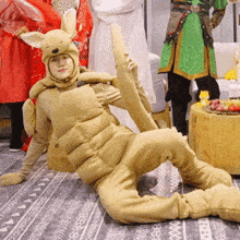 a person dressed in a kangaroo costume is laying on the floor