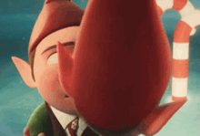 a close up of a cartoon elf holding a candy cane and kissing another elf .