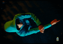 an aerial view of a person in a green hoodie giving the middle finger