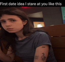 a girl with a tattoo on her arm that says abc