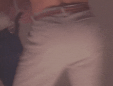 a blurry picture of a person 's butt and pants