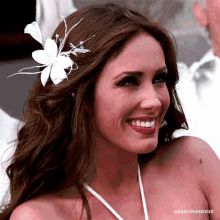 a woman with a flower in her hair is smiling and has the hashtag anahioverdose below her