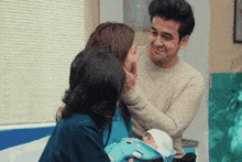 a man and woman are holding a baby in a hospital