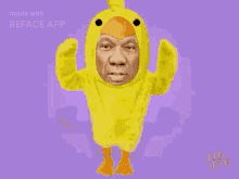 a man in a yellow duck costume is dancing .