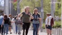 a group of people are walking down a street with the words hunted on the bottom