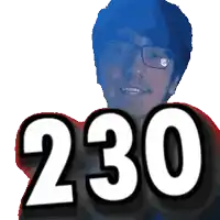 a man with glasses holds up the number 230 in front of his face