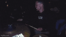 a man is playing drums with a cymbal that says evolve