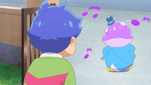 a boy in a green shirt stands next to a purple penguin