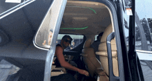 a man sits in the back seat of a car