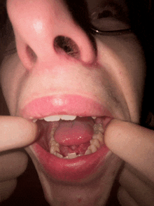 a close up of a person 's mouth with their tongue hanging out