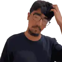 a man wearing glasses is scratching his head