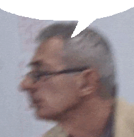 a blurry picture of a man wearing glasses with a speech bubble .