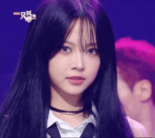 a girl with long black hair and a choker looks at the camera with a purple background that says ' korean ' on it