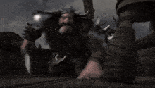a blurry picture of a man holding a sword in his hand .