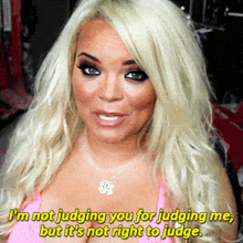 a blonde woman in a pink top says i 'm not judging you for judging me