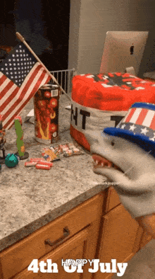 a 4th of july greeting with a shark puppet on the counter