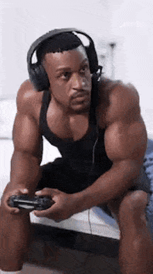 a very muscular man wearing headphones is playing a video game