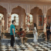 a man playing a guitar in front of a woman with a poster that says " you suck "