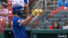 a baseball player wearing a helmet and gloves with id on the back
