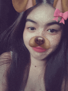 a girl with a fake dog nose and a pink bow on her head