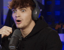 a man wearing headphones and a prime microphone