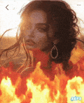 a picture of a woman surrounded by fire with xefx written on the bottom right